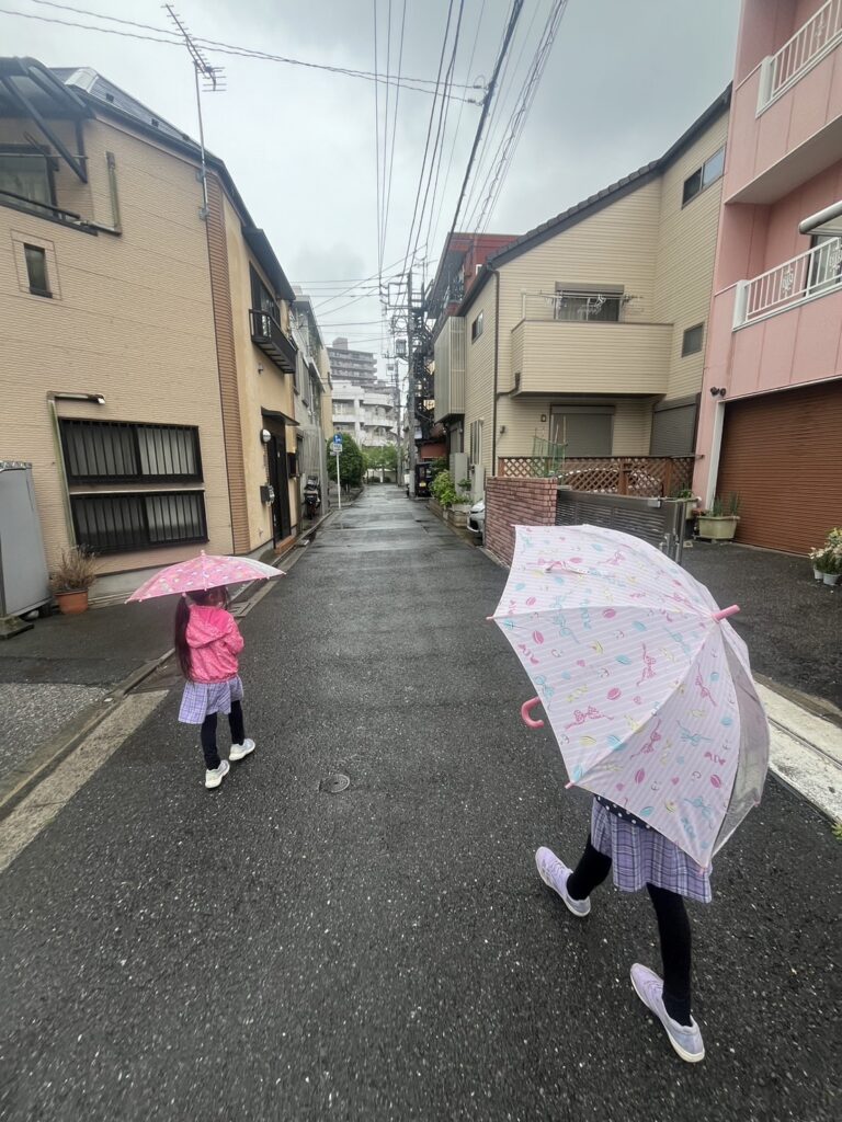 傘をさして歩く子ども,雨